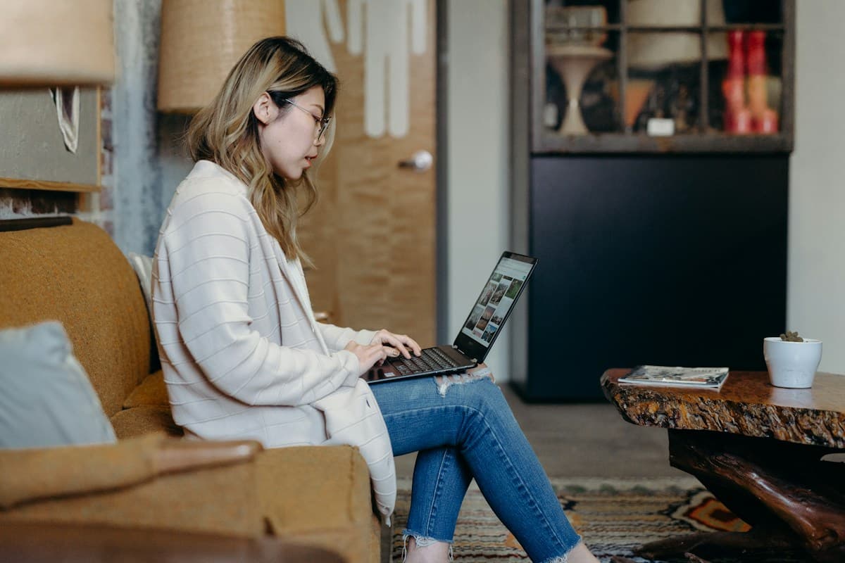 A woman working on her laptop in a cafe